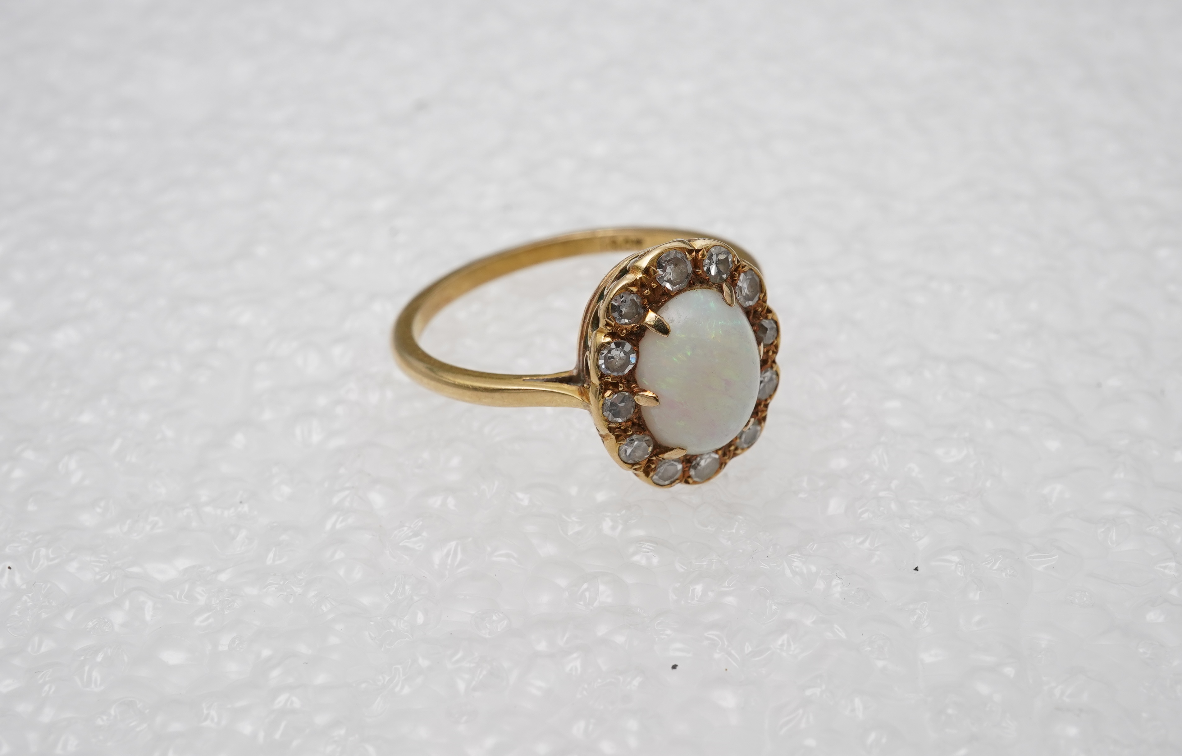 An opal and diamond cluster ring, mid 20th century